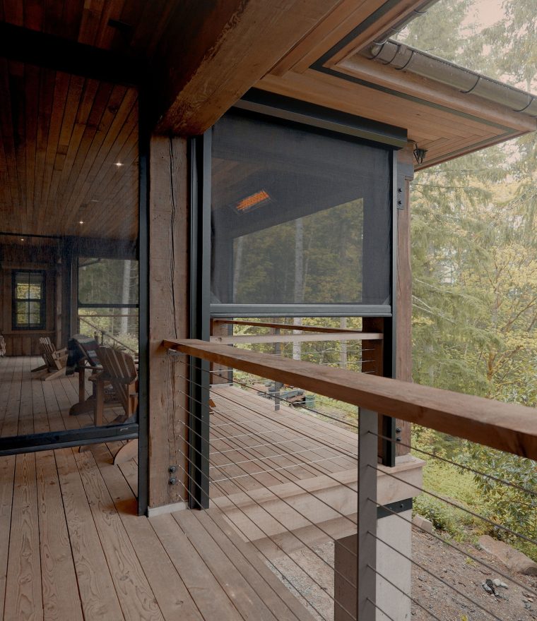 exterior of a rustic luxury cabin patio with motorized window screens